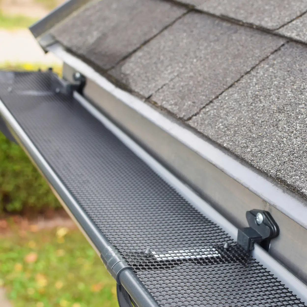 Residential home with asphalt shingles, gutters and gutter guards.