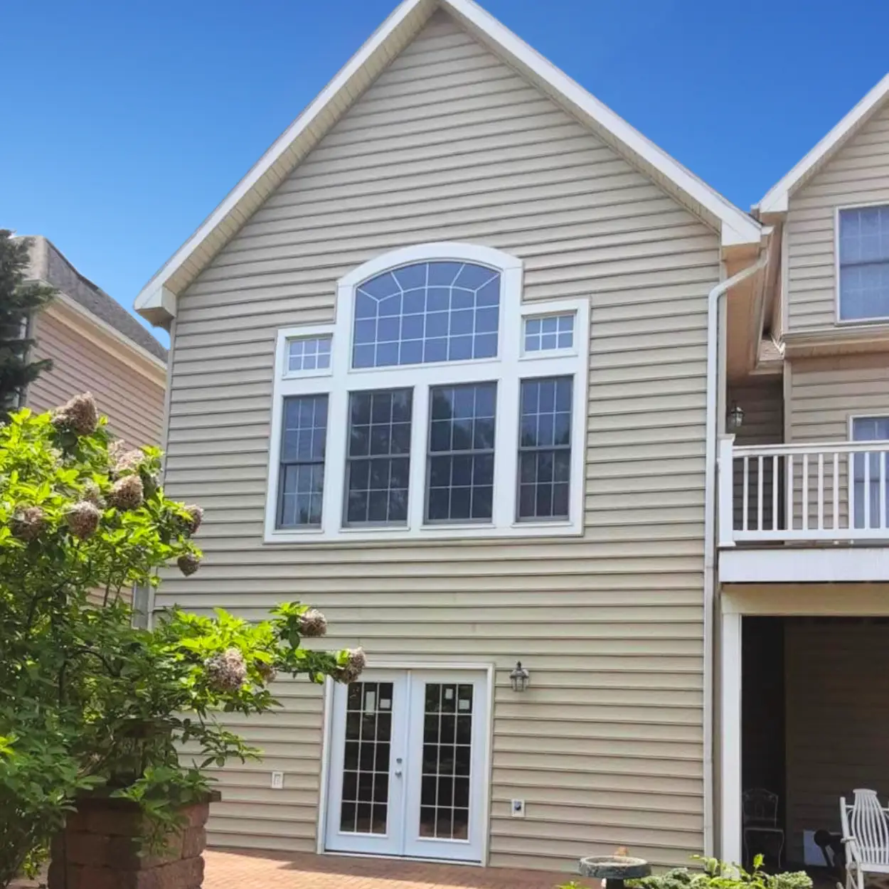 Two-story home with a newly installed vinyl siding.