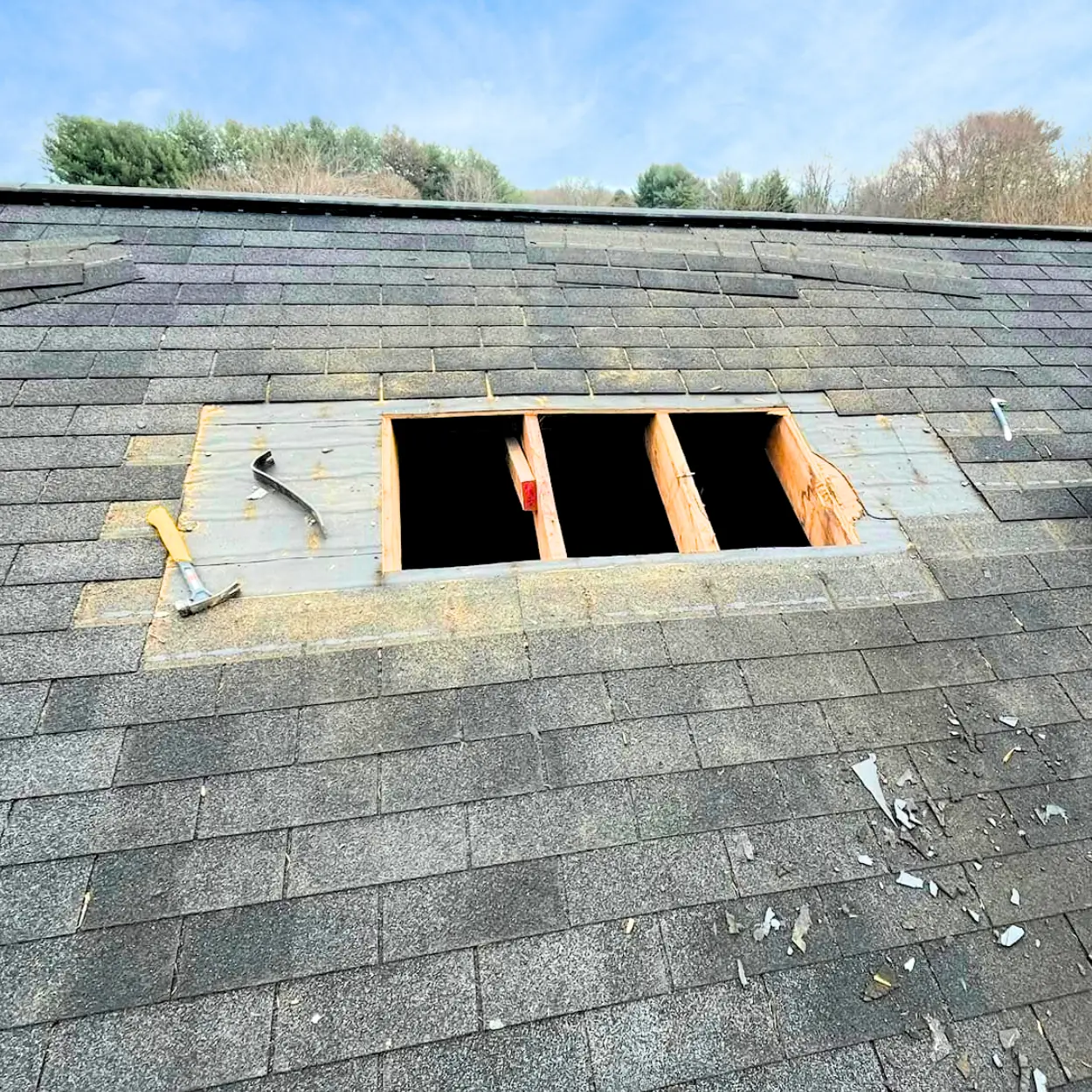 Three square sections removed from an asphalt shingle roof