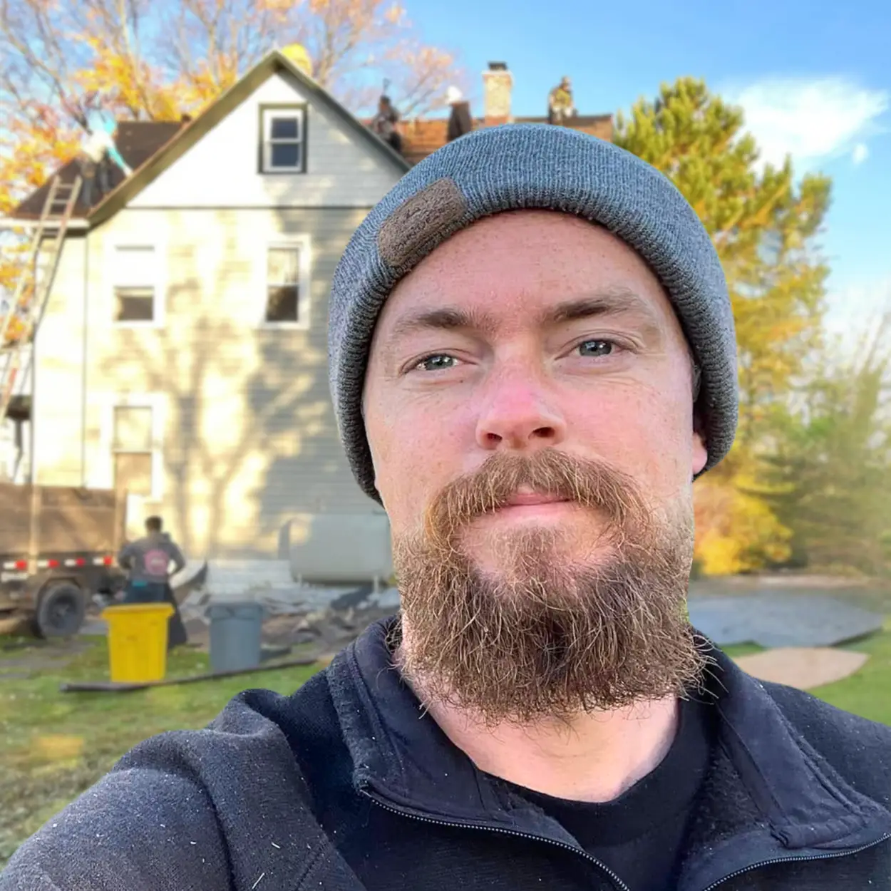 Owner of Rogers Roofing & Exteriors standing in front of a home undergoing roof replacement.