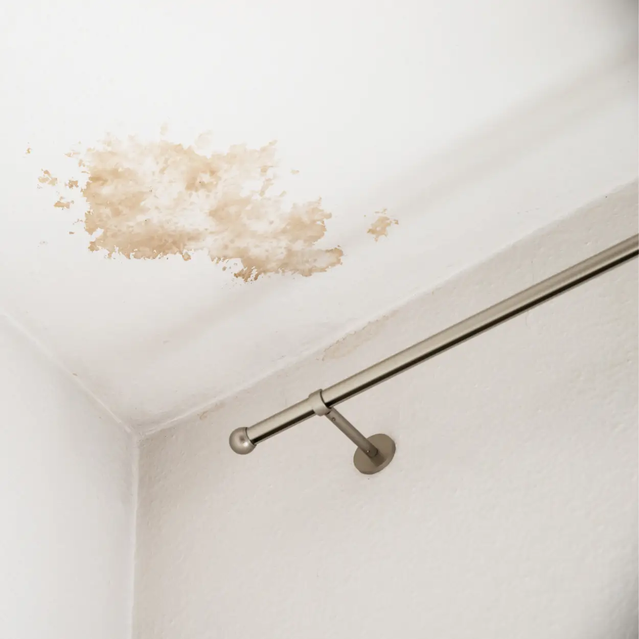 Ceiling with visible water stains and discoloration