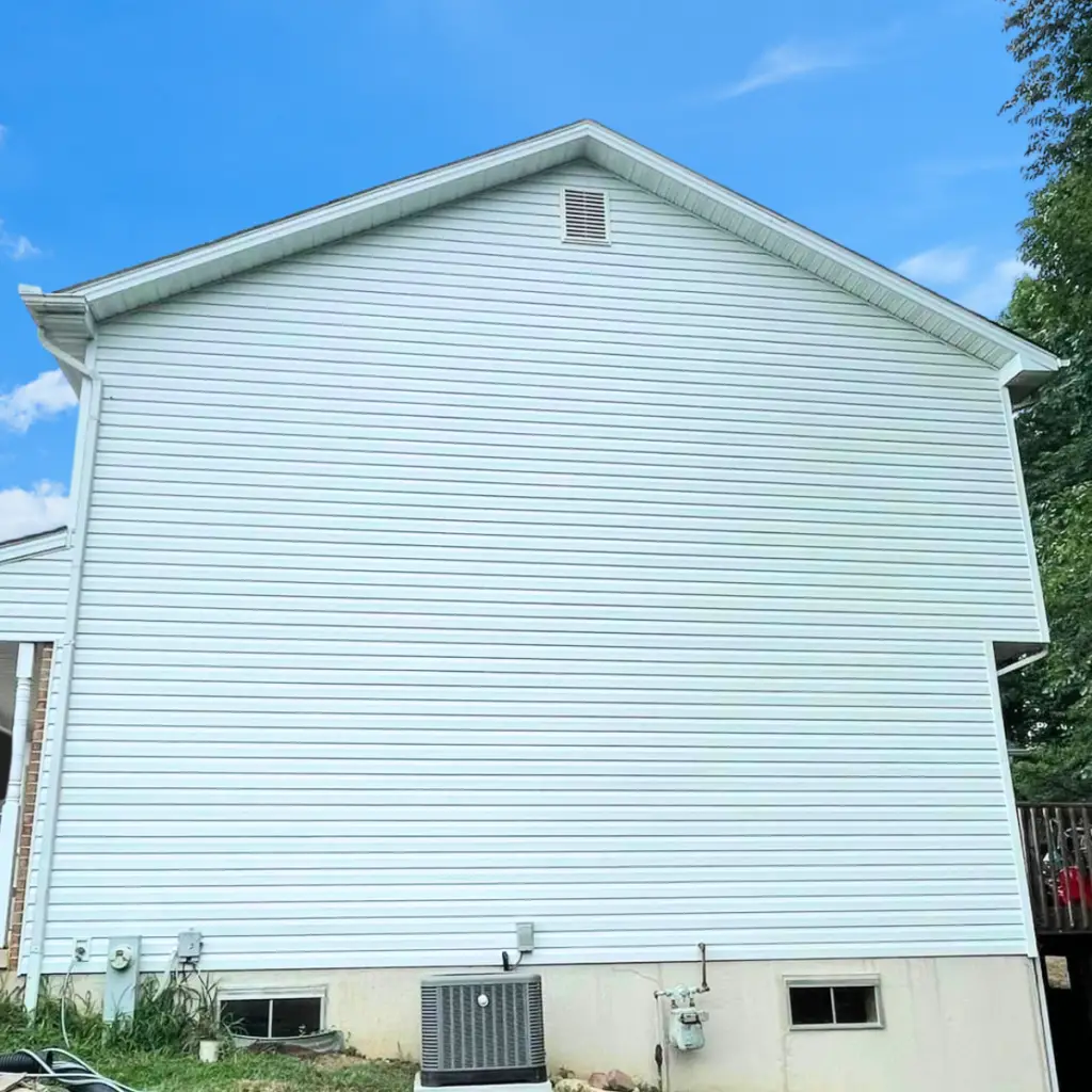 Two-story home with newly installed vinyl siding.